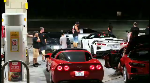 A red C6 Corvette parked at a gas pump at night, distinctive round taillights and Texas plate visible. A red C6 Corvette parked at a gas pump at night, distinctive round taillights and Texas plate visible.