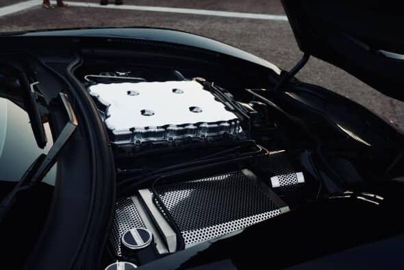 A close-up of a Corvette engine bay showing the V8 intake manifold and black trim, sharp and well-lit detail shot. A close-up of a Corvette engine bay showing the V8 intake manifold and black trim, sharp and well-lit detail shot.